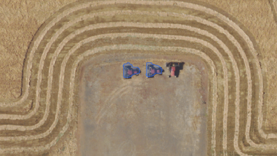 SAM 3 detecting tractors in a field.